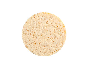 Close-up of a porous, circular beauty sponge against a black background