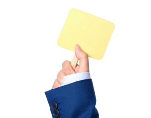 A person in a suit holds a small, yellow sign, isolated on a black background