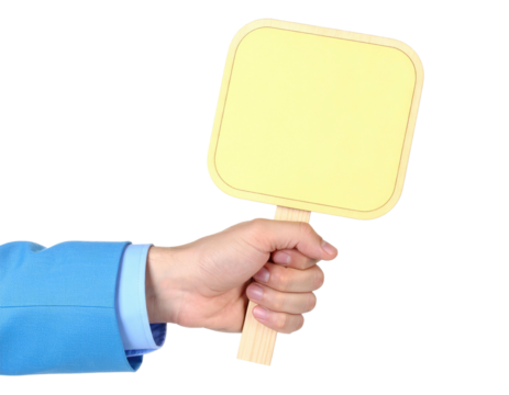 A person's hand grips a small, square sign, holding it against a stark black backdrop