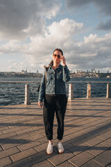 Mujer en el atardecer con gafas de sol posando a orillas del Bósforo en Estambul. Viajes y turismo...