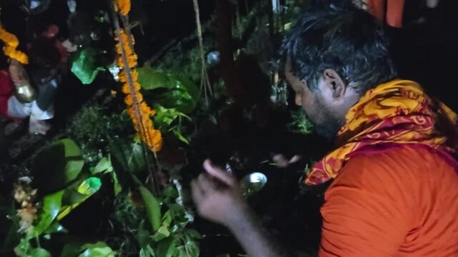 Authentic documentary footage of Kanwariya devotees gathering at a riverbank during the sacred Kanwar Yatra in India. Wearing traditional saffron clothing and carrying decorated Kanwars