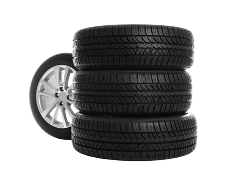 Stack of new tires with one wheel displayed next to it, set against black background