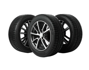 Obraz premium Three car tires with black treads and metallic rims on a solid black background