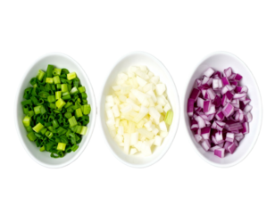 Three small white bowls holding chopped green, white, and red onions, set against a dark background