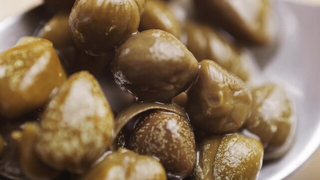 Pickled capers spanish food. Marinated buds of caper bush. Mediterranean cuisine ingredient. Organic spices and seasonings for meat, fish and vegetables, macro shot. Top view.