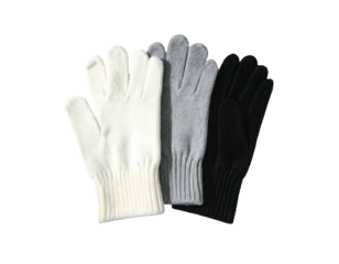Three knitted winter gloves in cream, gray, and black lay against a neutral background