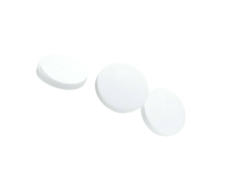 Three white, circular tablets, slightly rotated and floating against a stark black background