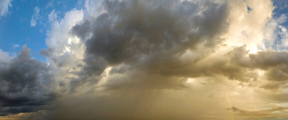 Stormy cumulus clouds forming during heavy thunderstorm on dark sky. Moving and changing cloudscape weather