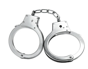 Metallic restraining devices, connected by a chain, against a stark black background