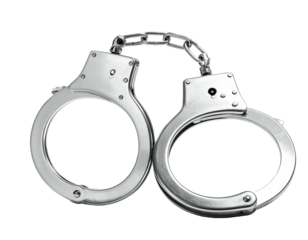 Metallic restraining devices, connected by a chain, against a stark black background