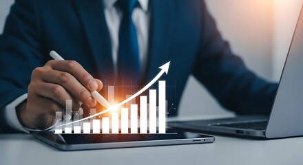 Business professional analyzing upward trending financial growth chart on digital devices