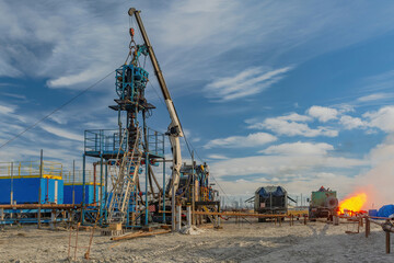 The Northern gas field. Summer. Installation for lowering a flexible pipe into a well. Equipment for testing and development of a gas well