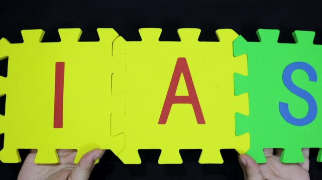 indian administrative service concept hands displaying foam tiles ias