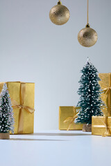 Vertical image with pine tree and golden boxes. Modern Christmas background for fashion, beauty, or...