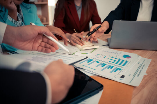 Data analysis meeting with business team using laptops and digital charts for strategic planning. With digital tablets and business graphs with data working in the office. - Powered by Adobe