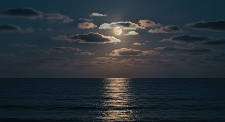 Full moon over calm ocean at night