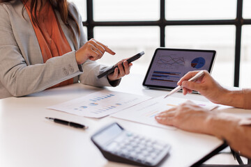 Business team to calculate financial information to invest in new projects. financial manager meeting.euing phone and laptop and digital tablet PCs in office.
