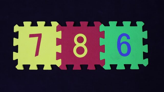 Islamic holy Number 786 on Jigsaw Puzzle on black background