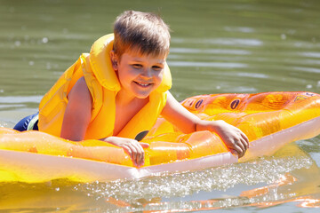 Cheerful smiling boy. Happy child portrait in water during summer vacation