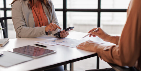 Business team to calculate financial information to invest in new projects. financial manager meeting.euing phone and laptop and digital tablet PCs in office.