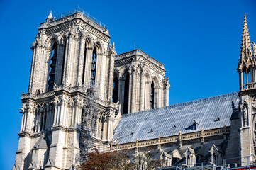 Historic cathedral architecture showcasing intricate stonework and towering spires against a clear blue sky, representing cultural heritage and artistry