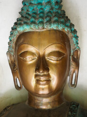 Bronze Buddha head with patina close-up