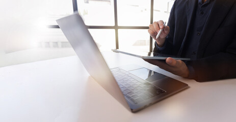A Businessman working on tablet computer analysis economy finance and sale data growth on interface icons, Banking, Finance, Business Strategy on global business Digital network connection technology.