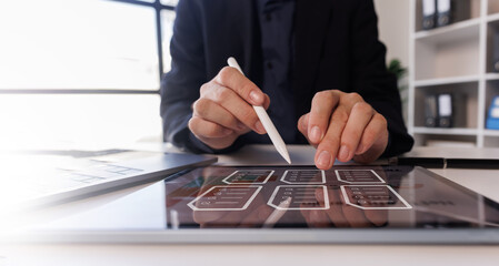 Document management concept with icons on virtual screen, ERP, Businessman working on laptop...