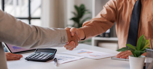 Professional business handshake during financial consultation with advisor, partnership agreement...