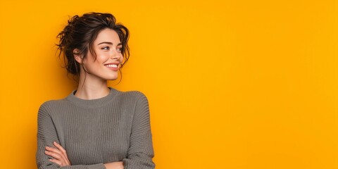 Model's head raised and looking forward,smiling,arms crossed,copy space,yellow background,banner