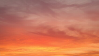 Fototapeta premium Sunset hues blending in a misty sky. Transitioning colors. Abstract nature backdrop with sky texture