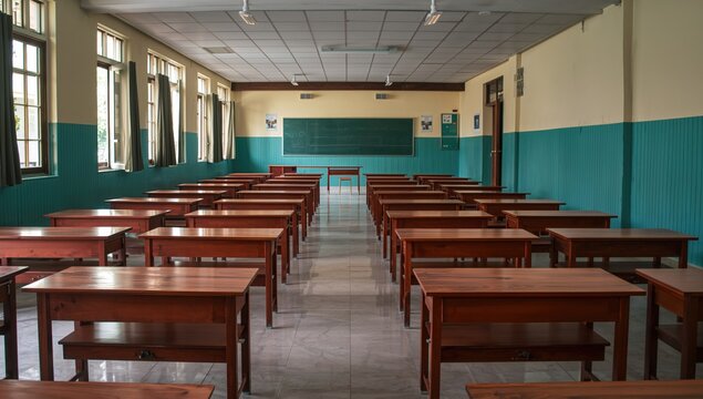Empty classroom featuring wooden desks and chairs, no students present during a pandemic lockdown