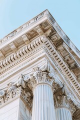 Fototapeta premium Column corner of government building against pale blue sky. Use law, history