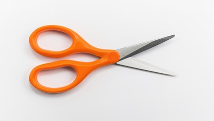 A pair of orange scissors set against a white backdrop
