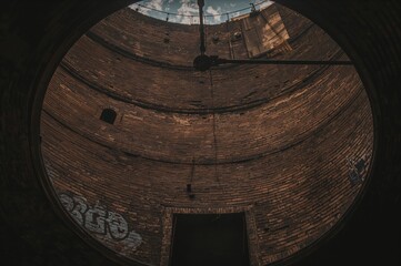 Deserted cylindrical brick reservoir up close.