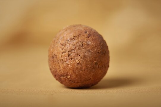 Close-up of homemade dried sweet potato balls showcasing texture and natural golden color in winter