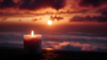 A lit candle burns on a wooden surface overlooking a serene sunset over the ocean
