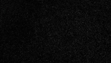 Fototapeta premium Detailed shot of a dark black carpet texture for indoor decor, showcasing a monochrome design.