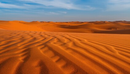 Naklejka premium Detailed view of orange sand grains in a vast desert expanse. Sand dunes close-up showcasing abstract patterns.