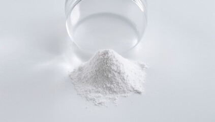 Close-up of chemical substance on a white laboratory surface. Petri dish holding di ammonium phosphate. Top-down perspective