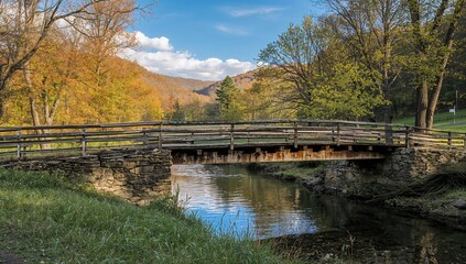 Obraz premium A shallow bridge crossing a rural stream in a valley region