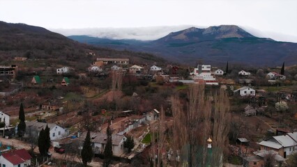 Aerial view of a mountain village and cloudy hills. Media