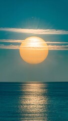 Sunset Over Calm Ocean With Golden Light Reflected On Silky Blue Water