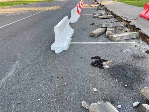 Road works, kerbstone replacement. Replacing curb stones or kerbs. Urban road.