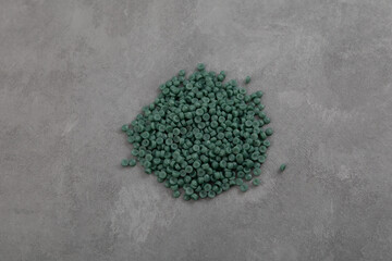 Pile of Recycled polypropylene granules rPE on grey background, top view. Granulated plastic polymer for production of plastic products. Secondary polypropylene