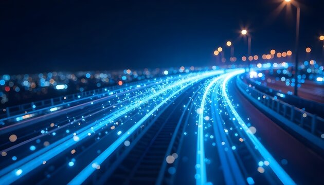 Blue light trails with bokeh effect, creating a sense of speed and movement, against a dark blue background with scattered light points