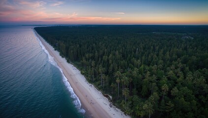 Fototapeta premium Aerial perspective of a tranquil shoreline featuring a sandy beach bordered by dense woodland, under a colorful sunset sky.