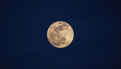 Detailed close-up of a nearly full moon illuminated by moonlight