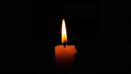 Close-up of a solitary candle flame against a dark backdrop