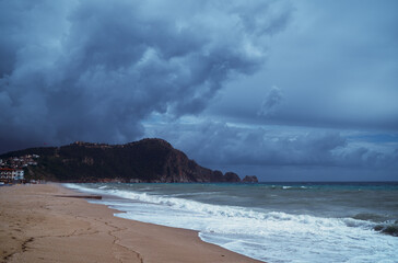 Dramatic Coastal Beach Scene with Stormy Sky and Rolling Waves